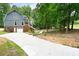 Exterior view showing the driveway, garage, yard, and entry stairs to the front porch at 4720 Timberland Sw Dr, Mableton, GA 30126