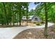 Charming single-Gathering home with landscaped front yard and a long concrete driveway surrounded by mature trees at 4720 Timberland Sw Dr, Mableton, GA 30126