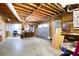 Spacious garage with exposed wooden beams and a gray garage door, offering storage and parking at 4720 Timberland Sw Dr, Mableton, GA 30126