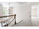 Upstairs hallway featuring a chandelier, staircase access, and a view to another room at 4720 Timberland Sw Dr, Mableton, GA 30126