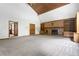 Open living room with vaulted ceilings, brick fireplace and built-in shelving at 4720 Timberland Sw Dr, Mableton, GA 30126