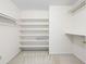 Walk-in closet offering ample shelving for organized storage and carpet floors at 4720 Timberland Sw Dr, Mableton, GA 30126
