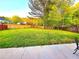 Expansive backyard offers ample green space, mature trees, and a patio area perfect for outdoor enjoyment at 522 Bass Nw Pointe, Kennesaw, GA 30144