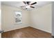 Bedroom with hardwood floors, ceiling fan and bright window with wood blinds at 522 Bass Nw Pointe, Kennesaw, GA 30144