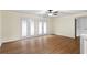 Bonus room featuring hardwood floors, ceiling fan, and glass panel doors at 522 Bass Nw Pointe, Kennesaw, GA 30144