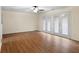 Bonus room featuring hardwood floors, ceiling fan, and glass panel doors at 522 Bass Nw Pointe, Kennesaw, GA 30144