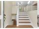 Bright foyer featuring hardwood floors, staircase with white railings, and plenty of natural light at 522 Bass Nw Pointe, Kennesaw, GA 30144