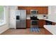 Well-lit kitchen featuring wood cabinets, stainless steel appliances, and durable countertops at 522 Bass Nw Pointe, Kennesaw, GA 30144