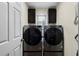 Laundry room features stainless steel washer and dryer and dark cabinetry at 522 Bass Nw Pointe, Kennesaw, GA 30144