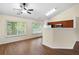 Spacious living area featuring hardwood floors, large windows, and an open layout connecting to the kitchen at 522 Bass Nw Pointe, Kennesaw, GA 30144