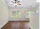 Open-concept living area with hardwood floors, large windows, and a seamless transition to the adjacent kitchen at 522 Bass Nw Pointe, Kennesaw, GA 30144