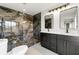 This bathroom has a walk-in shower with beautiful black marble tiles, and a double vanity at 801 Arbor Hill Dr, Stone Mountain, GA 30088