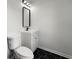 Cozy half bath with black hexagon tile flooring and a modern light fixture above the vanity at 801 Arbor Hill Dr, Stone Mountain, GA 30088