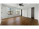 This bedroom features two windows, laminate floors, a closet and a ceiling fan at 801 Arbor Hill Dr, Stone Mountain, GA 30088