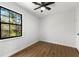 Bright bedroom with hardwood floors, ceiling fan, and a window with a view of nature at 801 Arbor Hill Dr, Stone Mountain, GA 30088