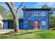 Charming two-story blue brick home with an orange front door and attached garage at 801 Arbor Hill Dr, Stone Mountain, GA 30088