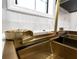 Modern gold kitchen sink with accessories and a window at 801 Arbor Hill Dr, Stone Mountain, GA 30088