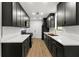 Modern galley kitchen with dark cabinets, gold hardware, and stainless steel appliances at 801 Arbor Hill Dr, Stone Mountain, GA 30088