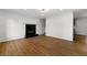 Cozy living room with hardwood floors and fireplace with black marble surround at 801 Arbor Hill Dr, Stone Mountain, GA 30088