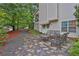 The backyard has a stone-paved patio with a metal seating area, perfect for enjoying outdoor living at 962 Cove Lake Ct, Lawrenceville, GA 30045