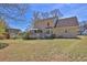 Spacious backyard with a well-maintained lawn, deck, and beautiful home exterior at 962 Cove Lake Ct, Lawrenceville, GA 30045