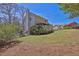 Backyard with a spacious lawn, deck, and tree foliage, perfect for outdoor activities at 962 Cove Lake Ct, Lawrenceville, GA 30045