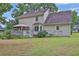 The backyard has a lush lawn with a covered deck and mature landscaping to enjoy outdoor relaxation at 962 Cove Lake Ct, Lawrenceville, GA 30045