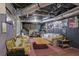 Basement with sofas, posters, and visible ceiling pipes, offering a relaxed space at 962 Cove Lake Ct, Lawrenceville, GA 30045
