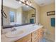 Bathroom featuring double sinks, a big mirror, and a shower, complete with light yellow walls at 962 Cove Lake Ct, Lawrenceville, GA 30045