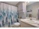Well-maintained bathroom with a forest-themed shower curtain and white cabinets at 962 Cove Lake Ct, Lawrenceville, GA 30045