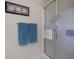 Clean bathroom featuring a glass enclosed shower, towel rack and decorative artwork at 962 Cove Lake Ct, Lawrenceville, GA 30045