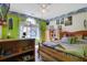 Bright bedroom showcasing a ceiling fan and large window, complemented by built in shelving at 962 Cove Lake Ct, Lawrenceville, GA 30045