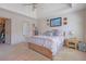 Relaxing bedroom featuring a tray ceiling, neutral tones, and a spacious walk-in closet at 962 Cove Lake Ct, Lawrenceville, GA 30045