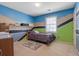 Unique bedroom with mural walls, a shelf, a window, and a cozy bed at 962 Cove Lake Ct, Lawrenceville, GA 30045