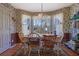 Comfortable dining room with a window view, charming wallpaper, and a wooden table with seating for Gathering gatherings at 962 Cove Lake Ct, Lawrenceville, GA 30045