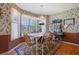Inviting dining room featuring a large window, hardwood floors, and a dining set for comfortable Gathering meals at 962 Cove Lake Ct, Lawrenceville, GA 30045