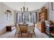 Charming dining room with large windows, decorative wallpaper, and a chandelier at 962 Cove Lake Ct, Lawrenceville, GA 30045
