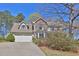 Attractive two-story home with a two-car garage, stone accents, and a well-kept lawn at 962 Cove Lake Ct, Lawrenceville, GA 30045