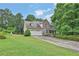 Charming two-story home with stone accents, a well-manicured lawn, and an attached two-car garage at 962 Cove Lake Ct, Lawrenceville, GA 30045
