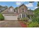 Beautiful two-story home with stone facade, bay window, and landscaped front yard at 962 Cove Lake Ct, Lawrenceville, GA 30045