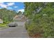 Attractive two-story home featuring a stone accent bay window, a covered car, and lush greenery at 962 Cove Lake Ct, Lawrenceville, GA 30045