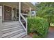 Inviting covered front porch with stairs, plants, and a comfortable seating area for relaxing at 962 Cove Lake Ct, Lawrenceville, GA 30045