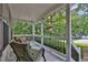 Comfortable front porch featuring a porch swing and chair perfect for enjoying the outdoors at 962 Cove Lake Ct, Lawrenceville, GA 30045