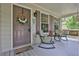 Charming front porch with seating, decor, and a welcome mat creating a cozy entrance at 962 Cove Lake Ct, Lawrenceville, GA 30045