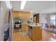 Bright kitchen featuring stainless steel appliances, wooden cabinets, and an adjacent dining area with natural light at 962 Cove Lake Ct, Lawrenceville, GA 30045