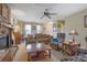 Bright living area with a ceiling fan, stone fireplace, and comfortable seating at 962 Cove Lake Ct, Lawrenceville, GA 30045