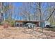 View of outbuilding with covered space, chairs, and additional storage potential in the backyard at 962 Cove Lake Ct, Lawrenceville, GA 30045