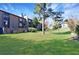 Exterior view of backyard with green grass, mature trees, and a wooden fence at 13 Ivy Ne Sq, Atlanta, GA 30342