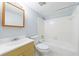 Bright bathroom with a shower-tub combo, a standard toilet, and a vanity with storage at 13 Ivy Ne Sq, Atlanta, GA 30342