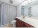 Cozy bathroom featuring tiled floors, a nice-sized mirror and a shower at 13 Ivy Ne Sq, Atlanta, GA 30342